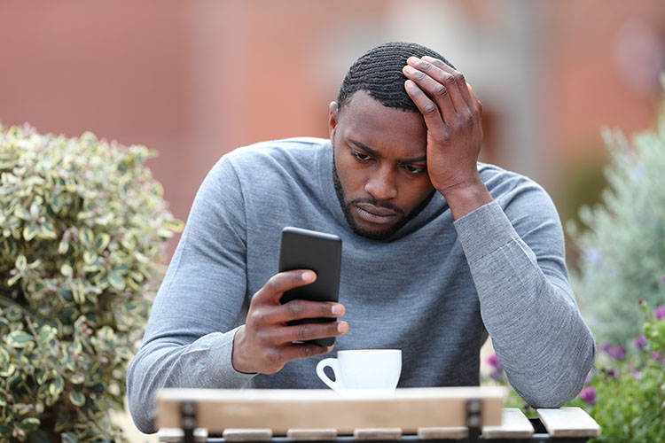 anxious man on phone looking for weed