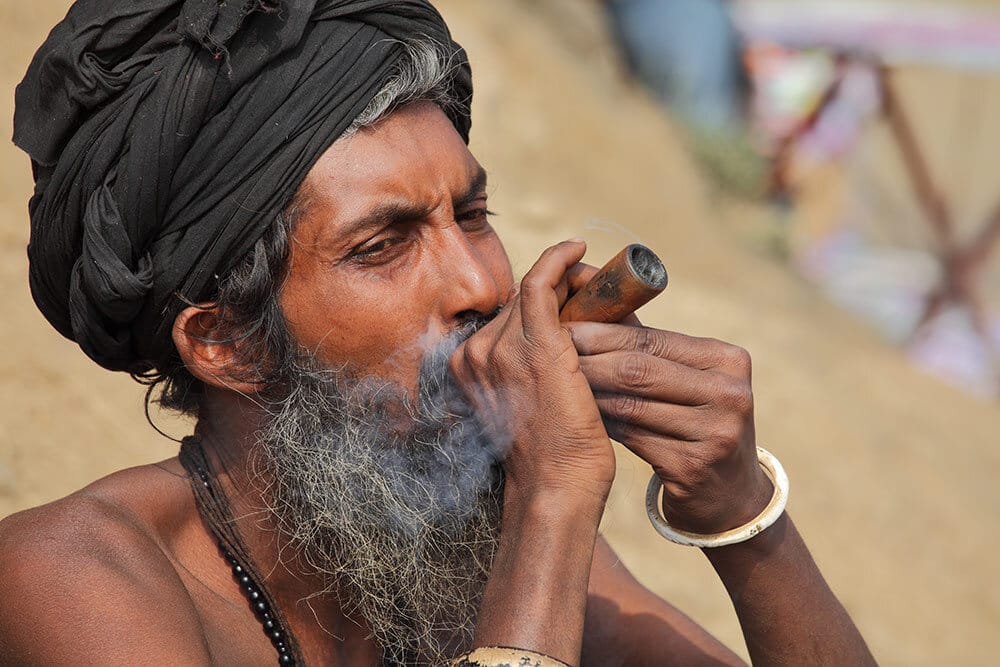 Man in India smoking marijuana with chillum