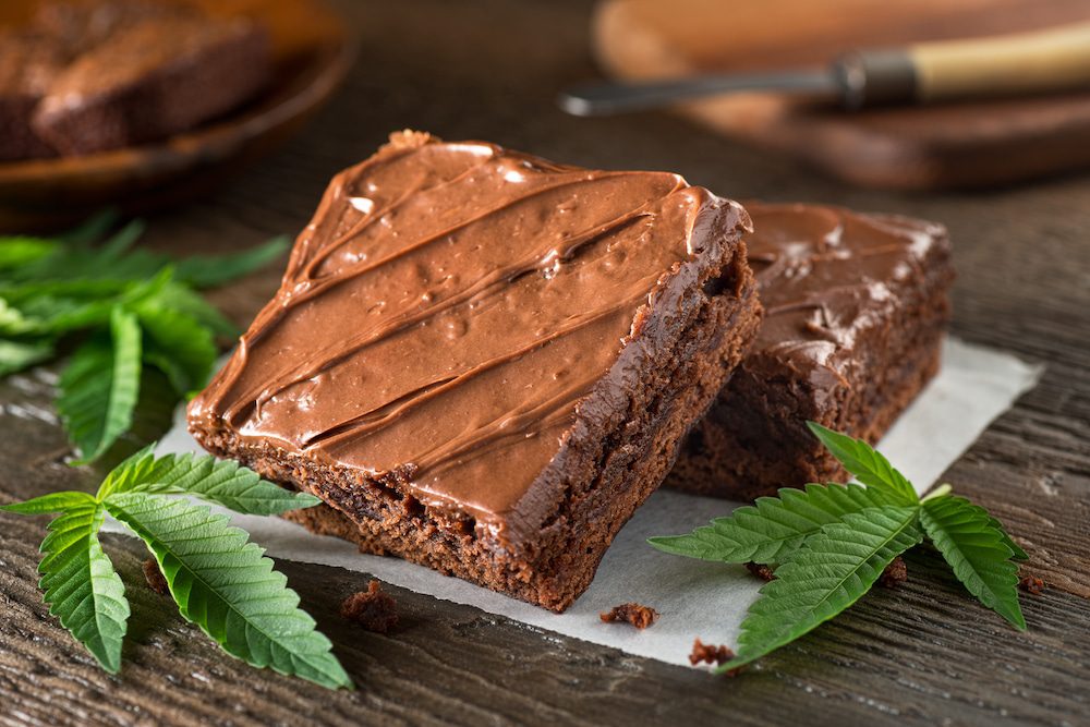 A plate of brownies with cannabis leaf