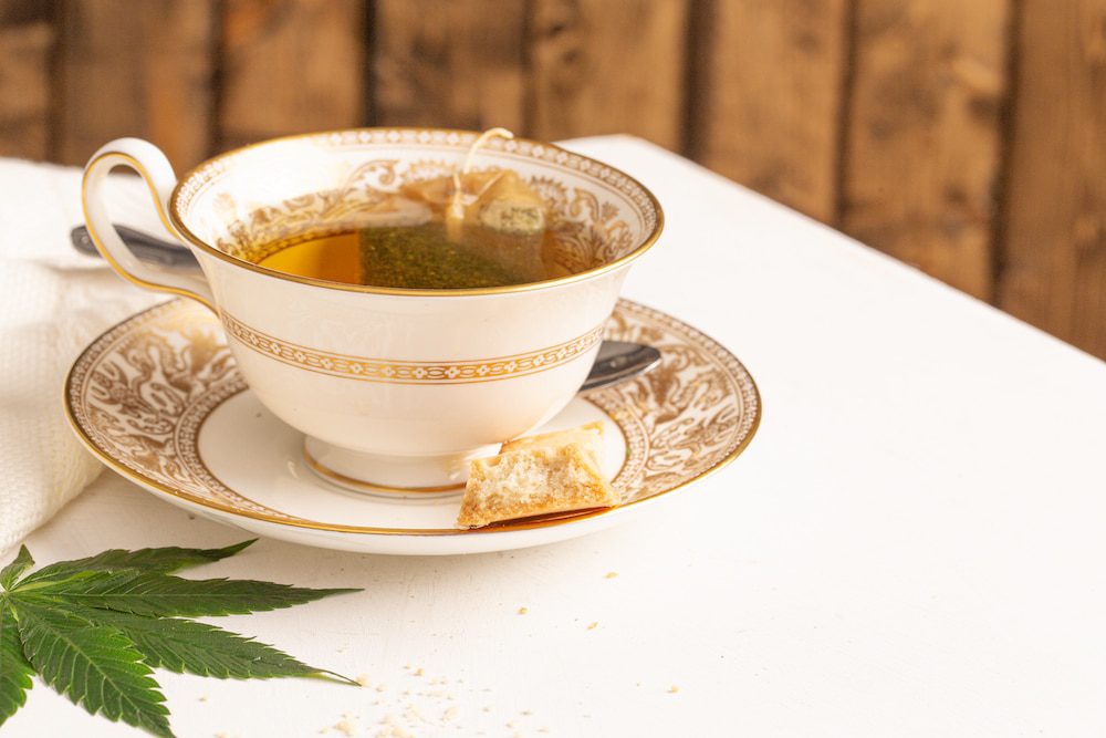 A cup of tea with a marijuana leaf