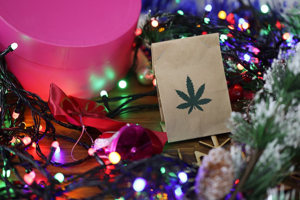 A paper bag of cannabis sitting in holiday lights