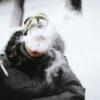 A snowboarder smoking weed on the mountain