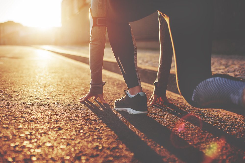 A female athlete gets ready for an early morning run