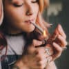 A young woman smokes a cannabis joint