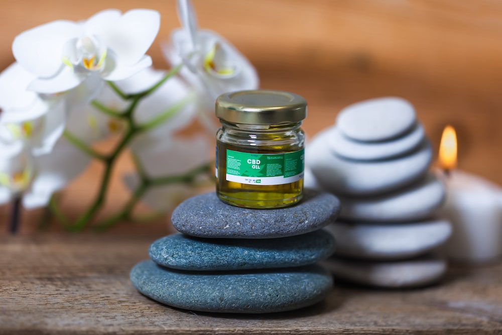 CBD oil and stones in a wellness spa setting
