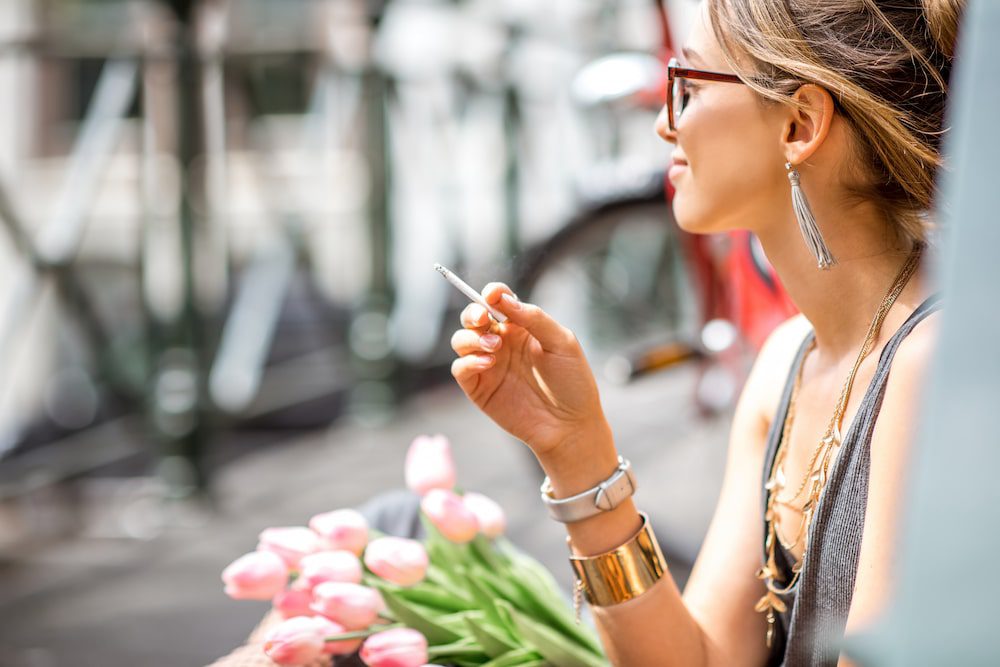 A young woman smoking cannabis outdoors