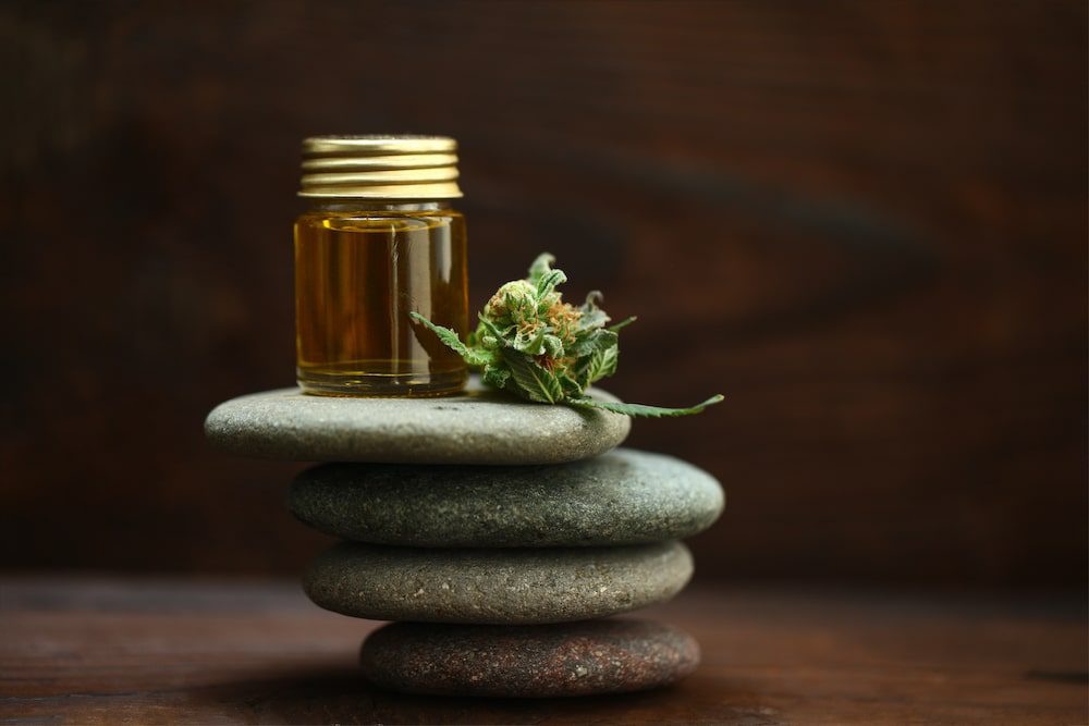 CBD oil stacked on top of massage stones