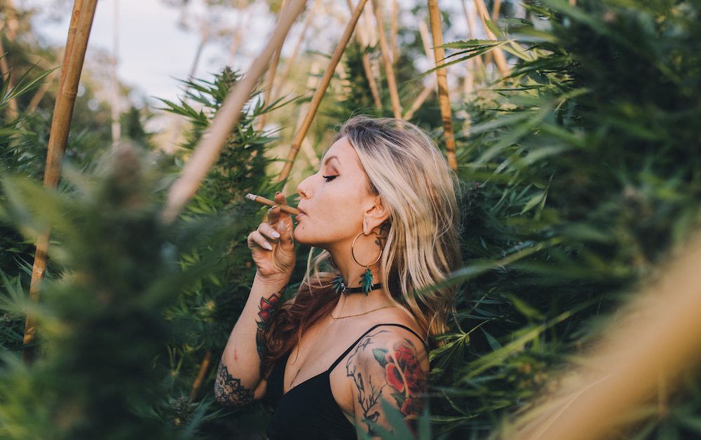 Woman smoking cannabis outdoors in a field