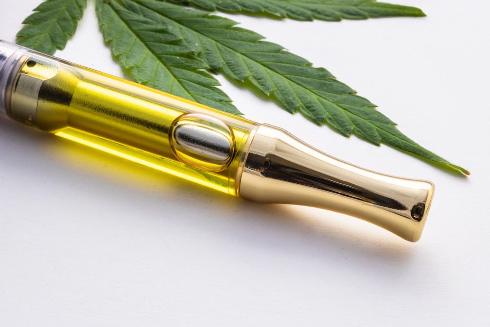 A cannabis vape pen on a table