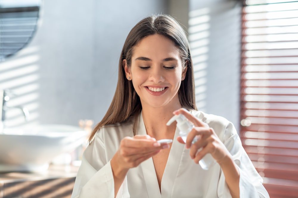 A young woman doing her skincare routine with cannabis products